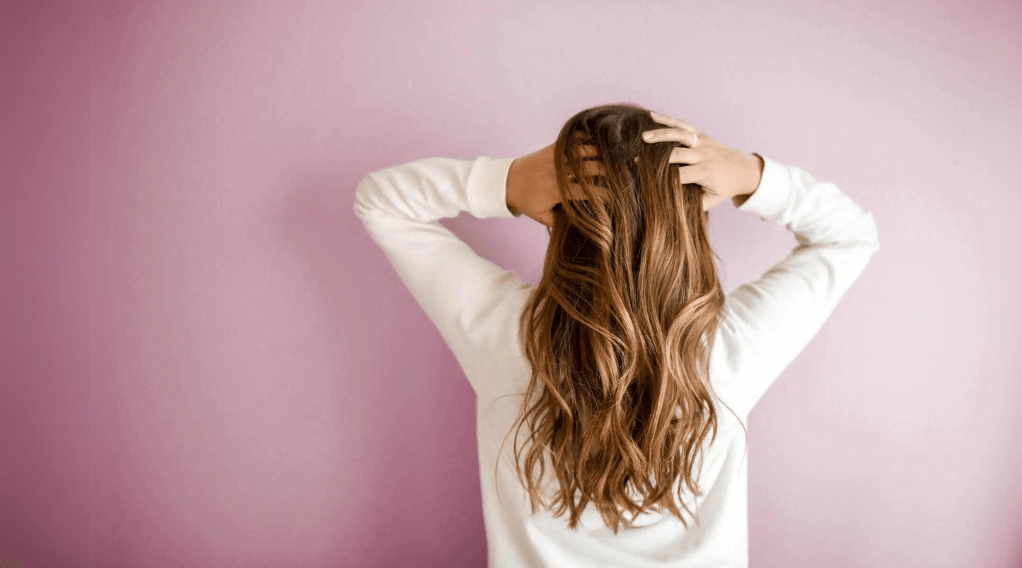 Woman running fingers through the back of her hair