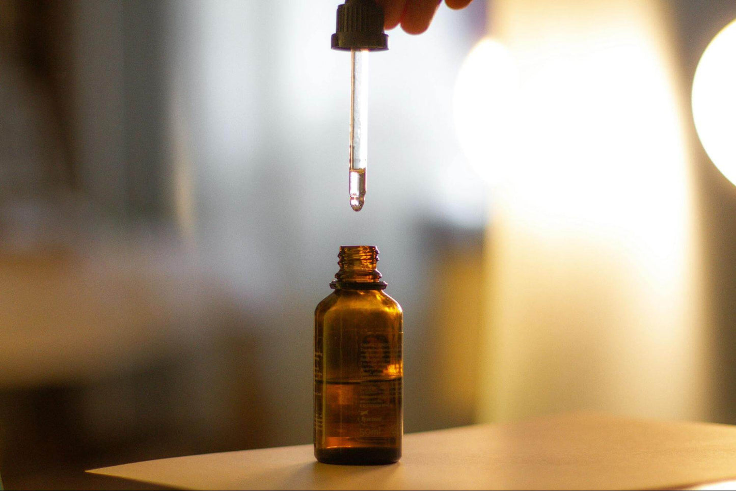 Close-Up Shot of a Person Holding a Serum Bottle