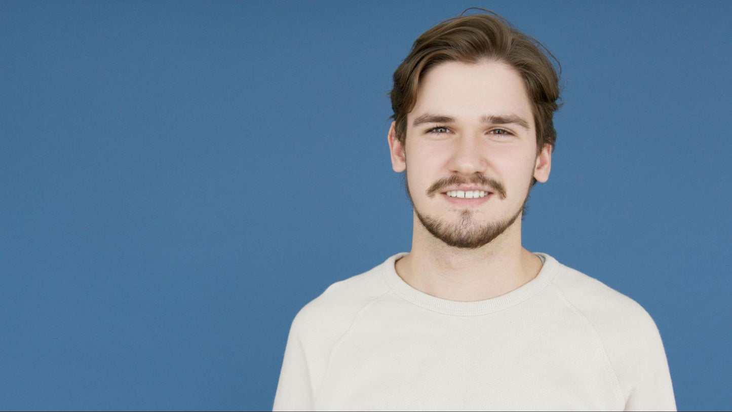 Man Smiling in Blue Background