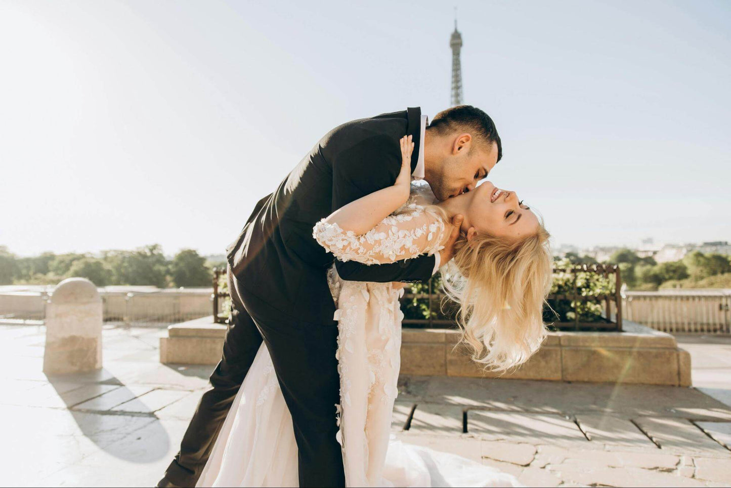 Groom kissing bride's neck