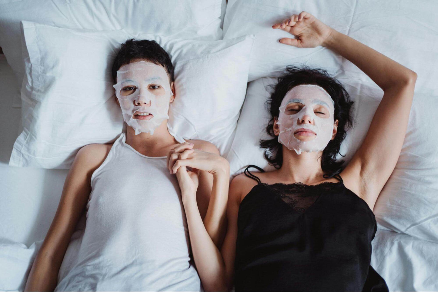 Women with Beauty Masks Lying Together in Bed