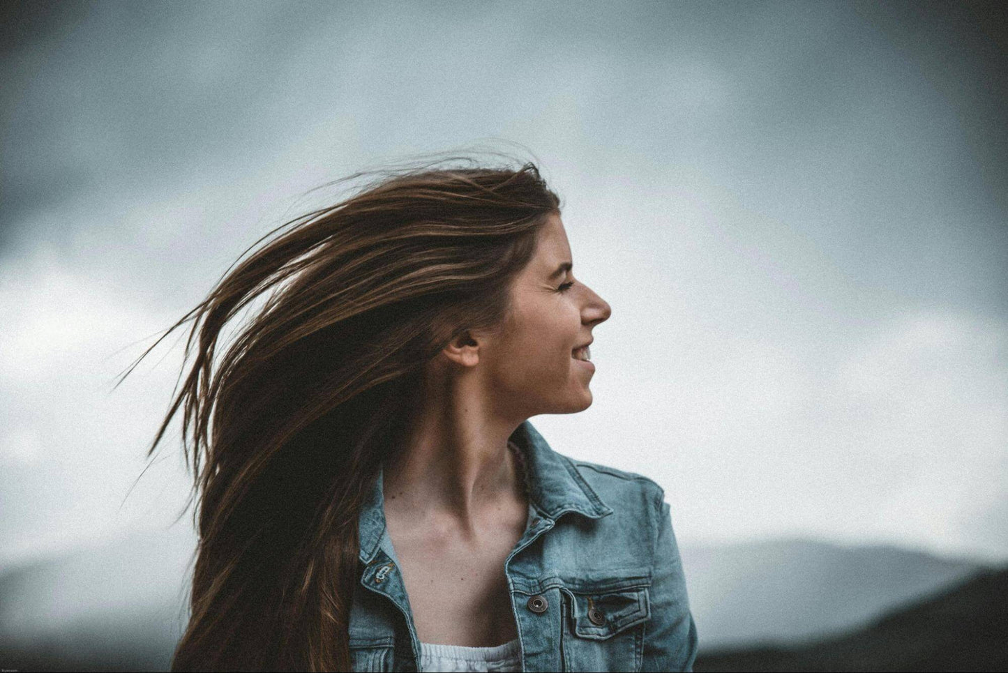 brunette woman with windswept hair