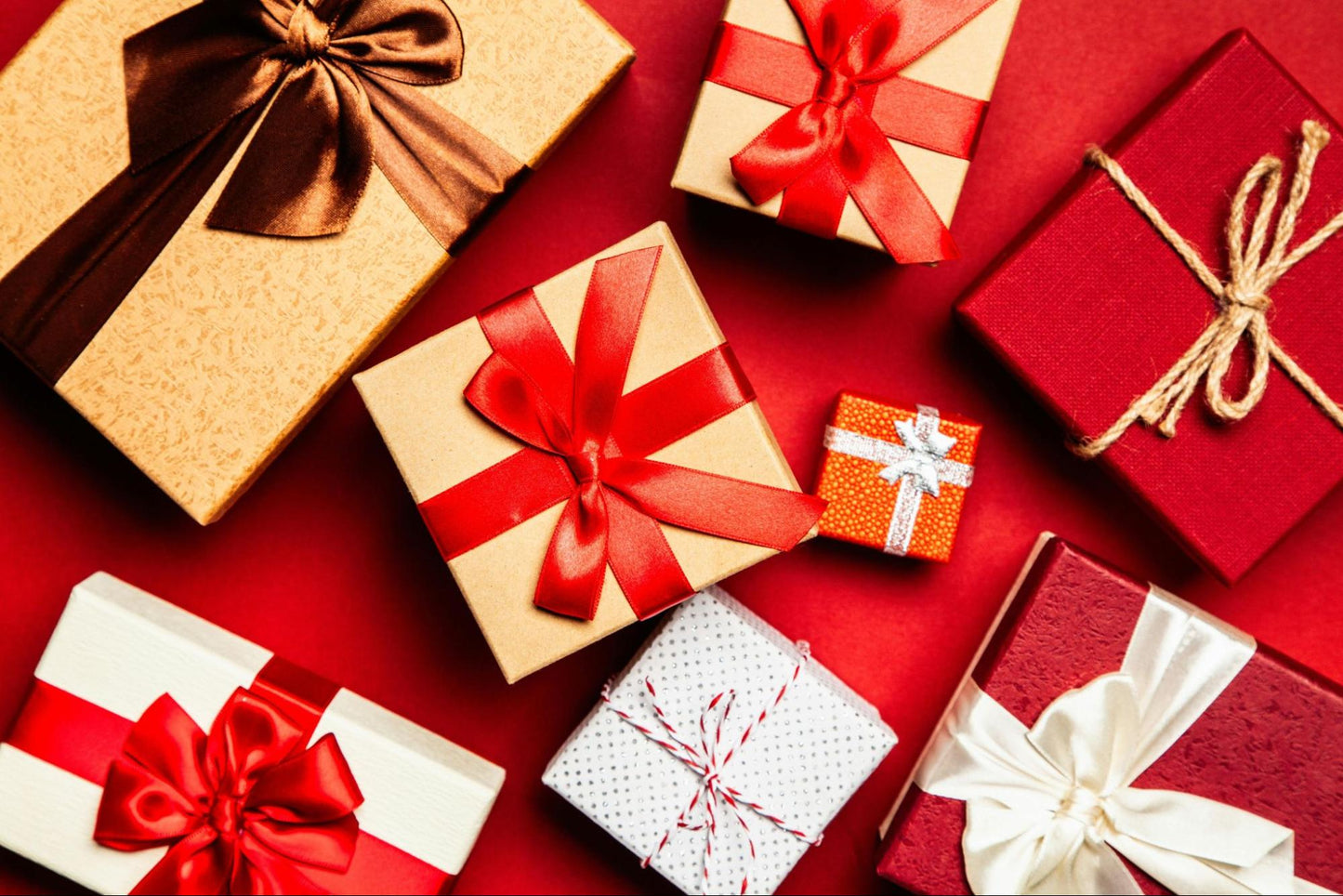 Wrapped presents scattered along red background