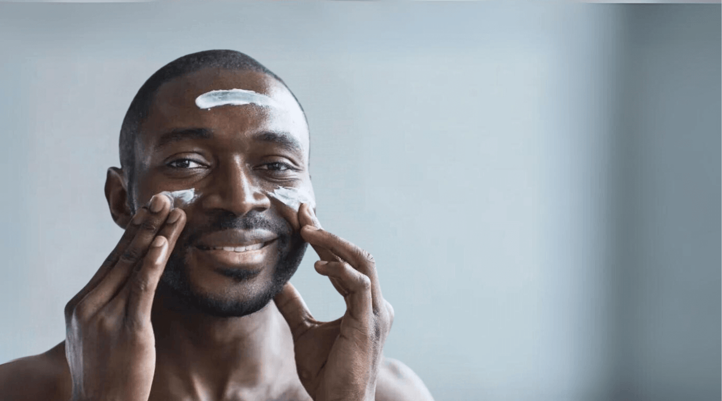 man applying lotion to face