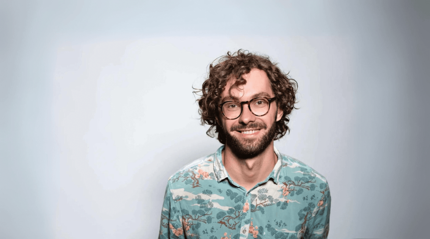 man with curly hair smiling